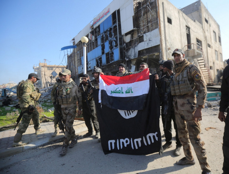 Iraqi security forces hold an Iraqi flag