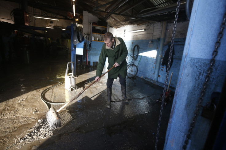 man cleans after york floods