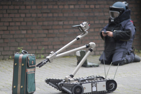 Remote-controlled robot inspects suitcase for bombs