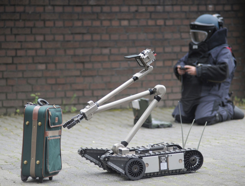 Remote-controlled robot inspects suitcase for bombs