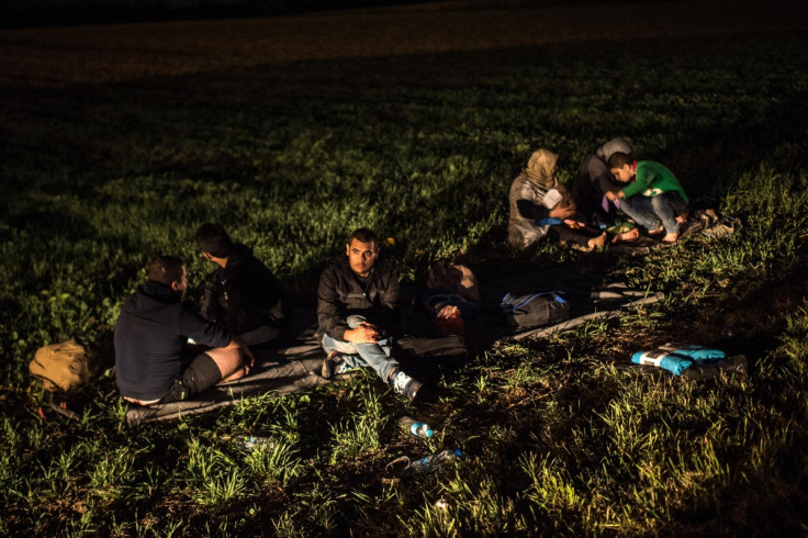 Migrants rest by the road Migrants rest by the road