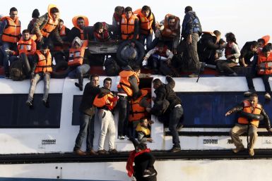 Syrians struggle to leave a half-sunken catamaran
