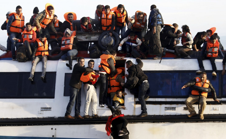 Syrians struggle to leave a half-sunken catamaran