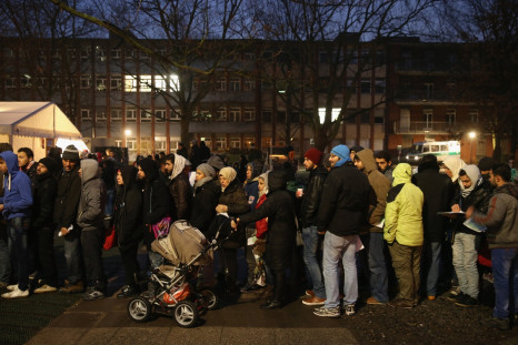 Refugees and migrants queue to register atanasylumcentre