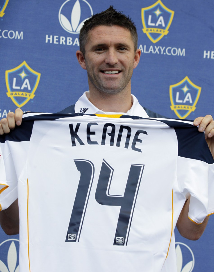 Ireland's Robbie Keane holds up a jersey after signing with MLS soccer team Los Angeles Galaxy in Carson, California