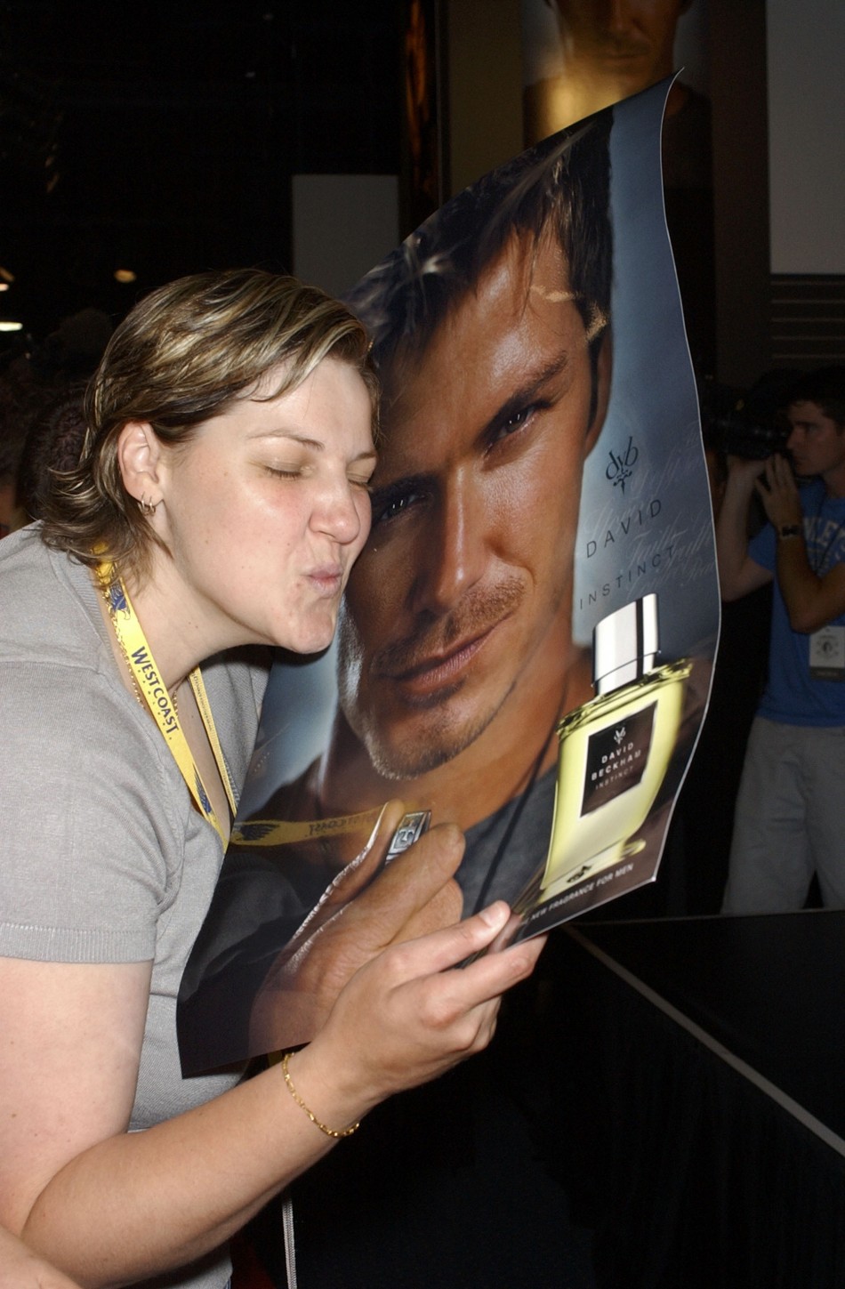 A fan kisses David Beckham039s poster during a promotional event to launch his new fragrance quotIntimately Beckham Nightquot in Sydne
