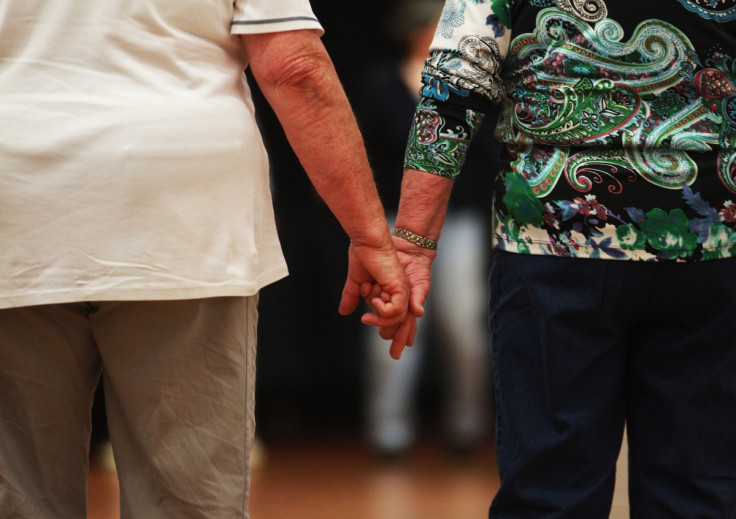 Elderly couple holding hands