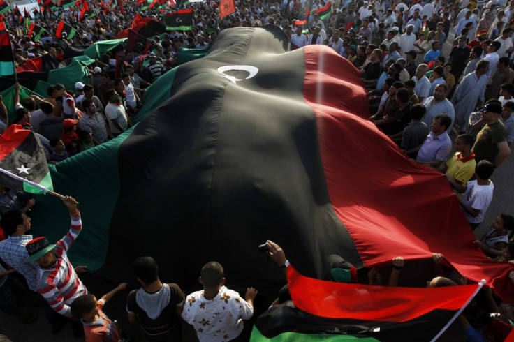 Protesters carrying a Libyan flag
