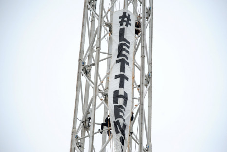 Protesters climb a spire