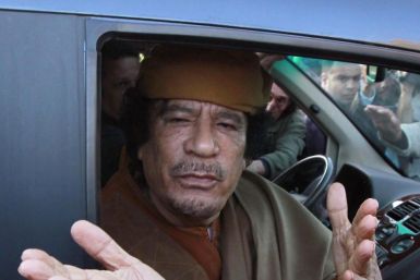 File photograph of Libyan leader Moammar Gadhafi gesturing from a car in the compound of Bab Al Azizia in Tripoli