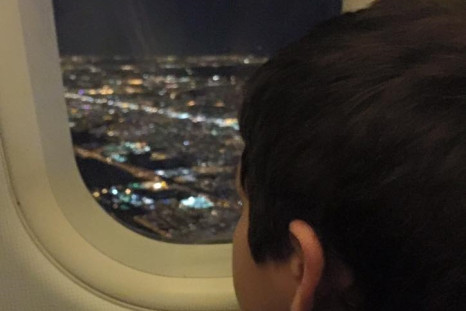 Passengers clap as boy leaves flight