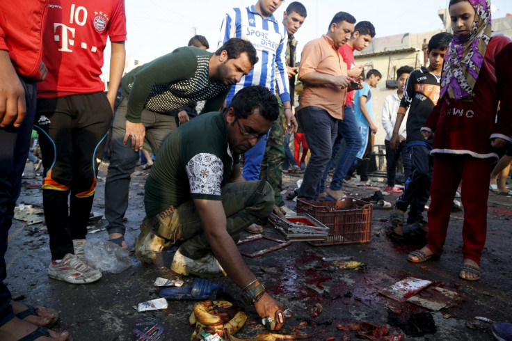 People gather at the site of suicide blasts in Baghdad