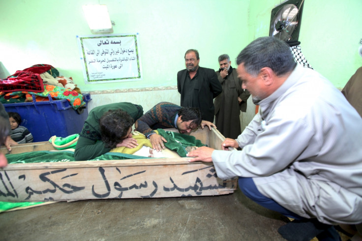 Mourners react over the coffin