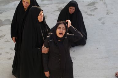 A woman reacts during a funeral