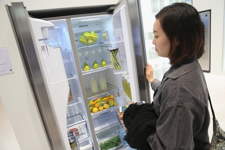 A woman looking at a fridge