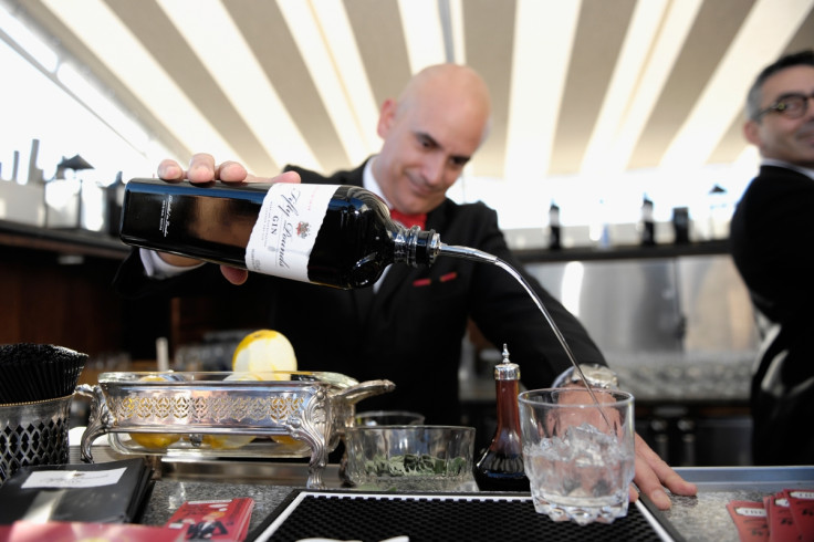 A bartender pours gin