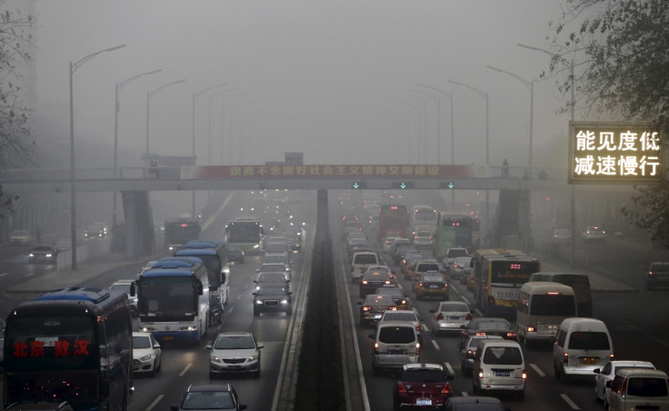 Vehicles are seen on a street amid heavy smog in Beijing