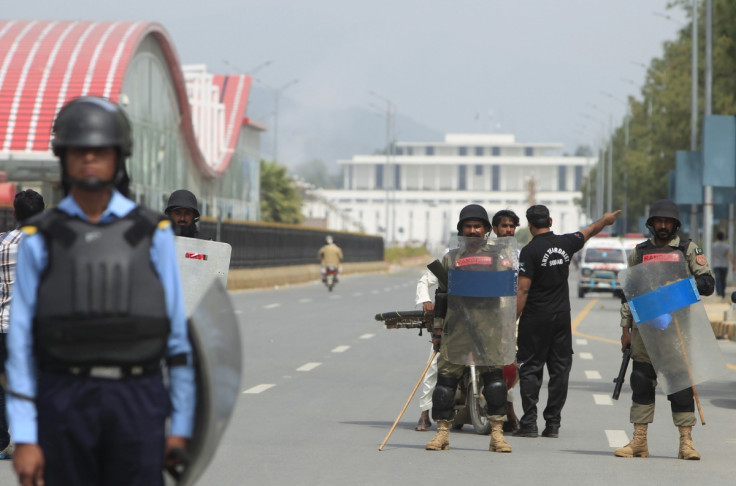 Security officials guard on a road leading towards Parliament building after clashes between protesters. Security officials guard on a road leading towards Parliament building after clashes between protesters.