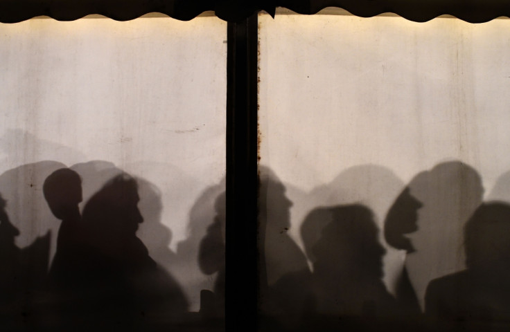 Refugees queue to register at a asylumkcentre