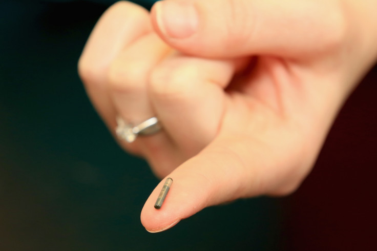 A microchip held out by a nurse