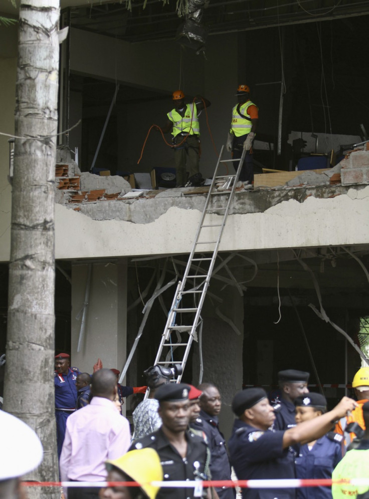 U.N. staff are seen after a bomb blast that ripped through the United Nations offices in the Nigerian capital of Abuja
