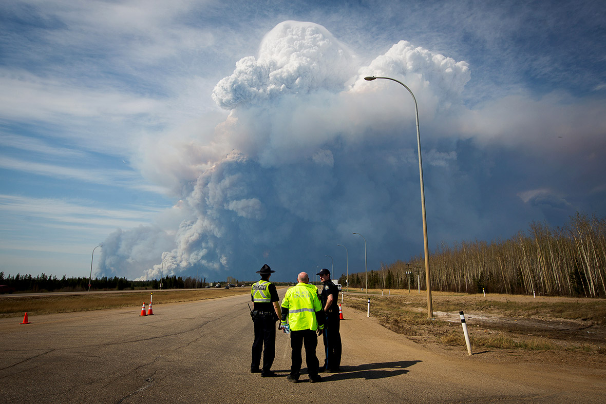 Alberta wildfire moves south, forcing more evacuations in Canada's oil