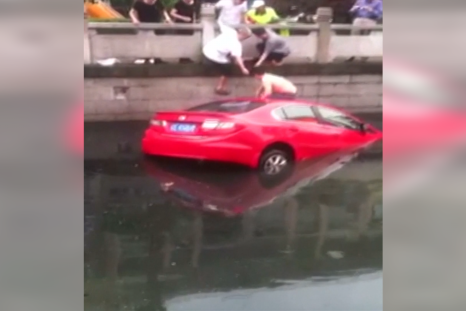 A woman was rescued from her car in east China's Jiangsu Province after she crashed into a river.