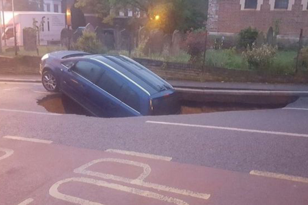 car falls down hole in Greenwich