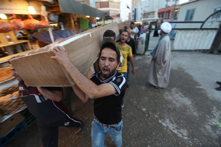 Mourners carry the coffin of their relative