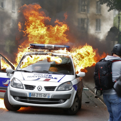 French protesters destroy police car