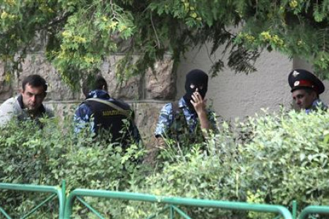 Police officers take a break in front of Baksanskaya hydroelectric power station in the Kabardino-Balkaria region, near the town of Baksan