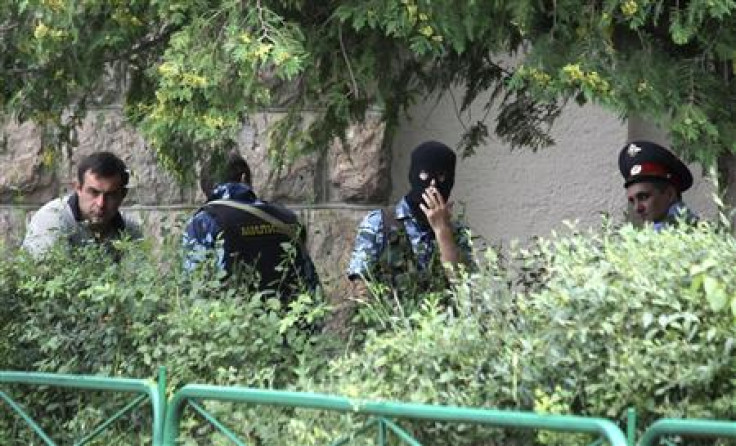 Police officers take a break in front of Baksanskaya hydroelectric power station in the Kabardino-Balkaria region, near the town of Baksan