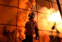 A Spartak Moscow fan lights a flare