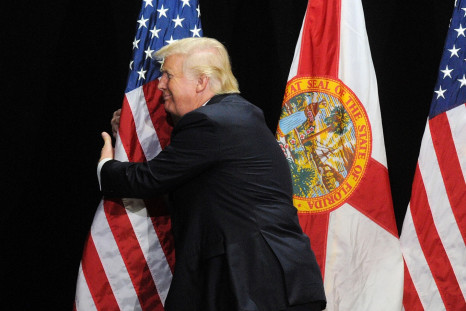 Donald Trump hugging a flag