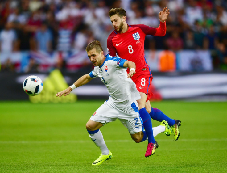 Adam Lallana challenges for the ball