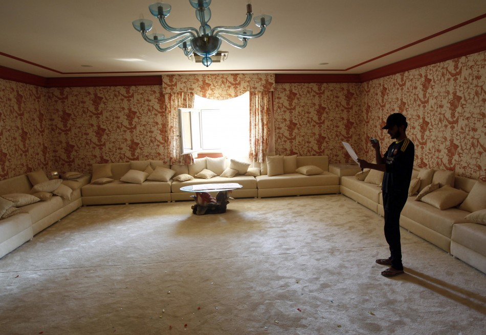 A man stands inside the house of Aisha, the daughter of Libyan leader Moammar Gadhafi in Tripoli August 26, 2011. REUTERSGoran Tomasevic