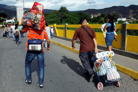 Venezuelans carrying food