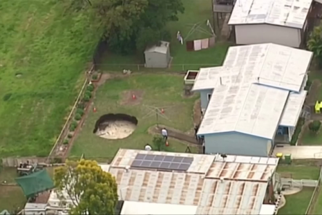 Sinkhole opens up overnight and eats away at Australian couple's back garden