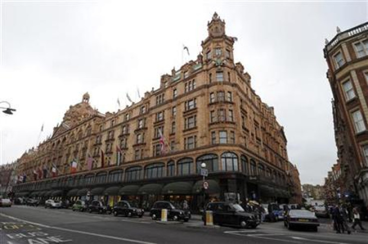 Traffic passes the Harrods department store in London