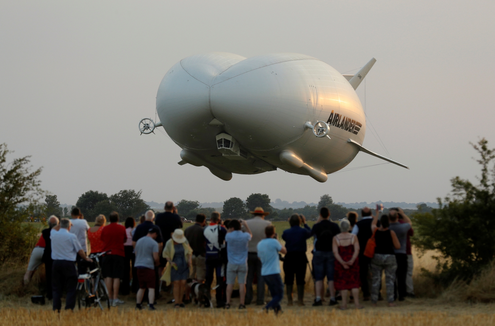 Cheering spectators gather to watch the 'Flying Bum' on its maiden