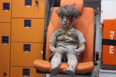 boy rubble Aleppo Syria