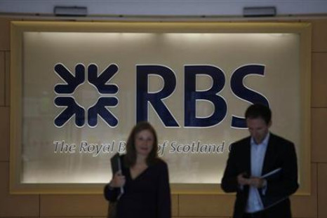 Two people walk out of the headquarters of the Royal Bank of Scotland in the City of London