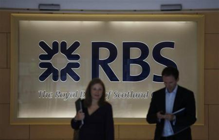 Two people walk out of the headquarters of the Royal Bank of Scotland in the City of London