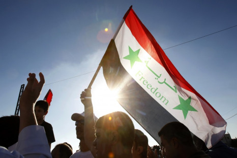Syrians living in Jordan shout slogans against Syrian President Bashar al-Assad after morning prayers on the first day of Eid Al-Fitr outside the Syrian embassy in Amman
