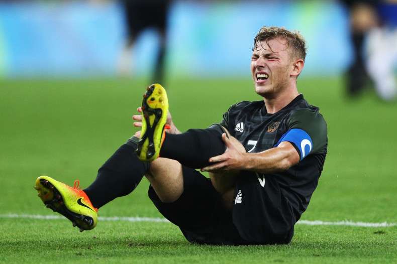 Max Meyer goes down with cramp