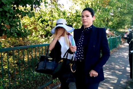 Lisa Murphy in hat with her solicitor