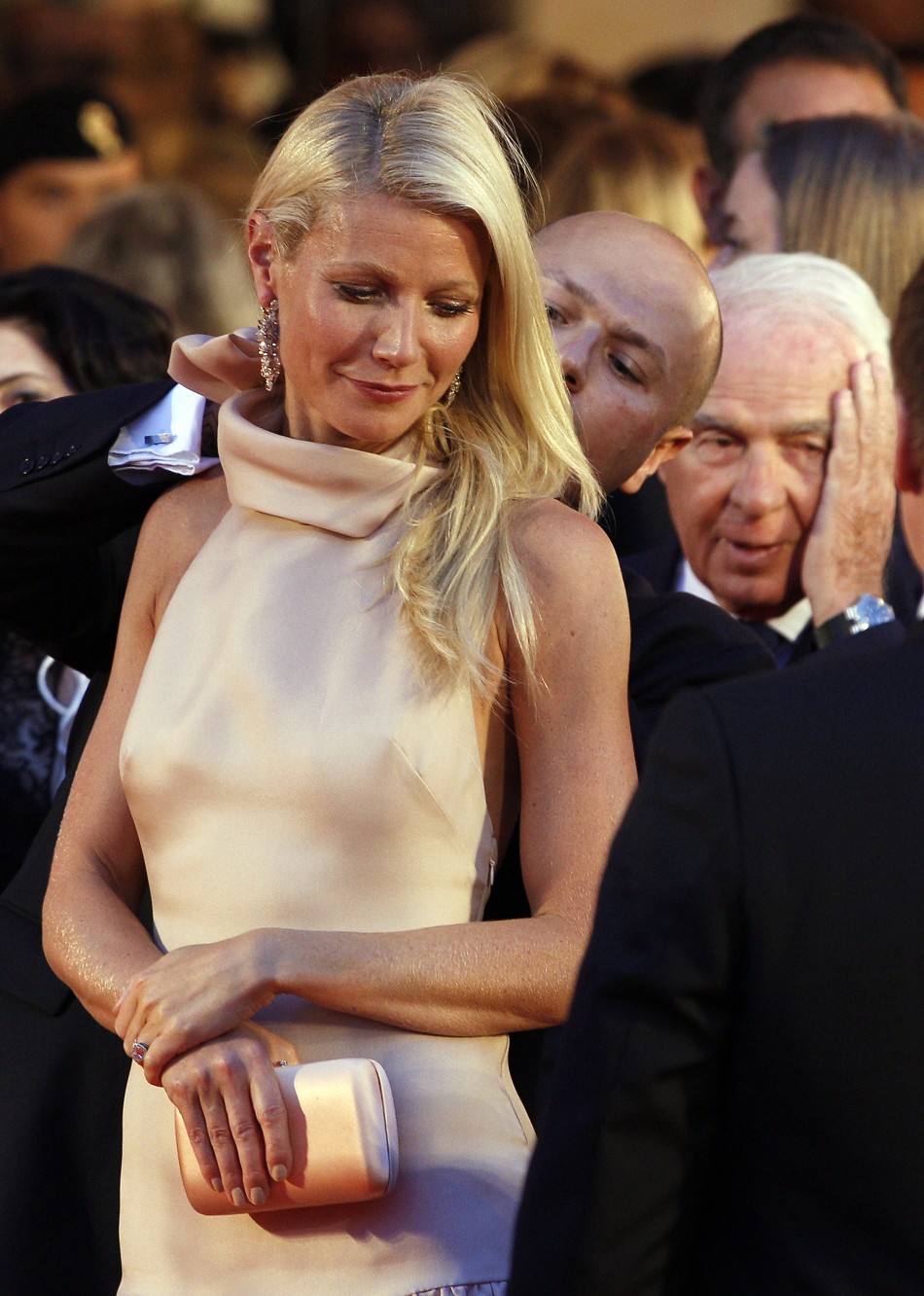 Actress Paltrow, cast member of movie quotContagionquot, is helped by assistant as she arrives on red carpet at Cinema Palace during 68th Venice Film Festival
