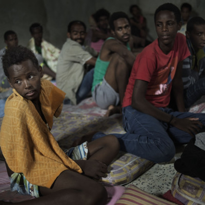12-year-old Sagga, from Eritrea, sits with other adolescent boys