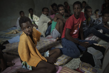 12-year-old Sagga, from Eritrea, sits with other adolescent boys