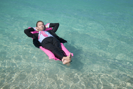 Businessman relaxes on lilo
